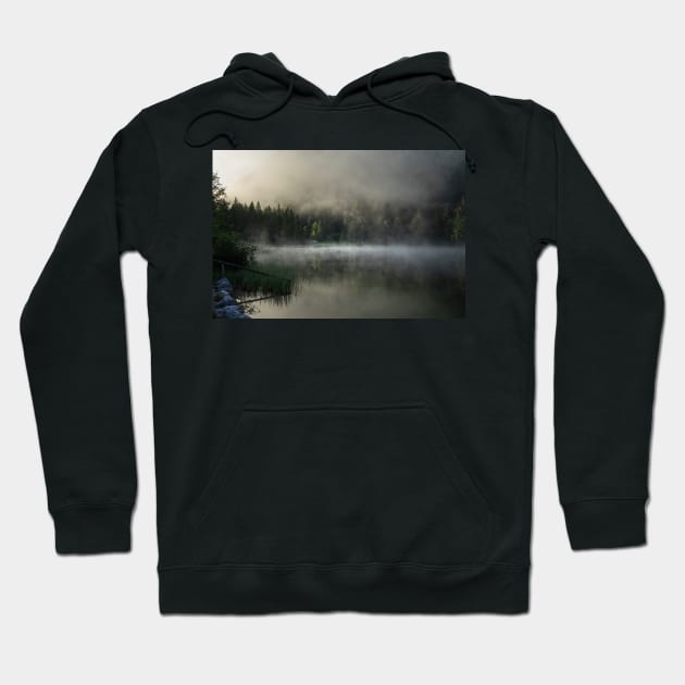 Misty Lake 2. Amazing shot of a wooden house in the Ferchensee lake in Bavaria, Germany, in front of a mountain belonging to the Alps. Scenic foggy morning scenery at sunrise. Hoodie by EviRadauscher